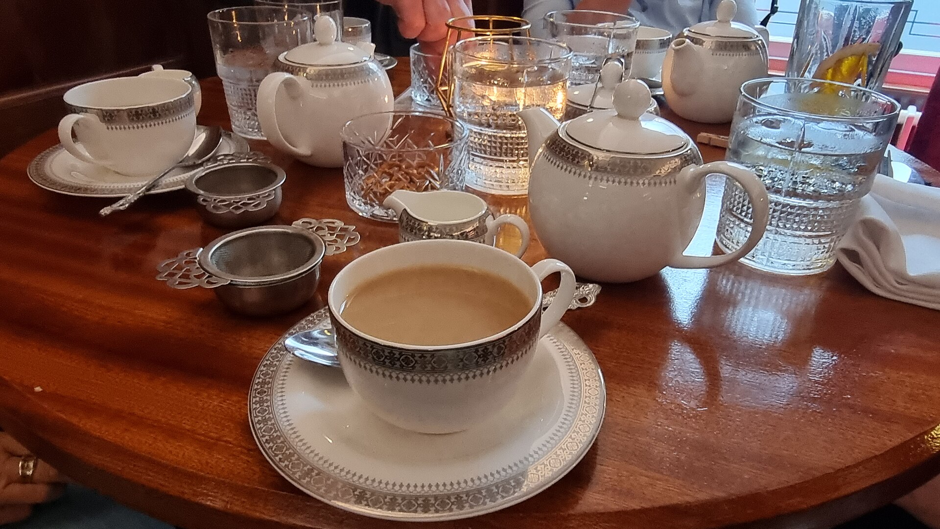 A tiered afternoon tea stand with scones and small cakes