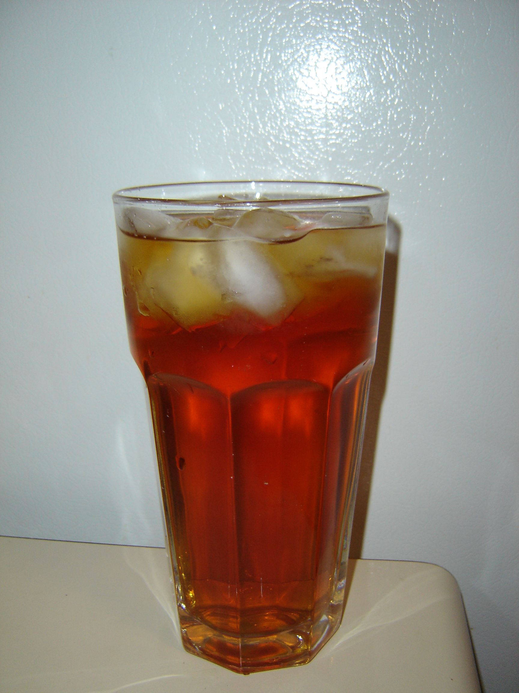 A cup of cloudy iced tea on a table