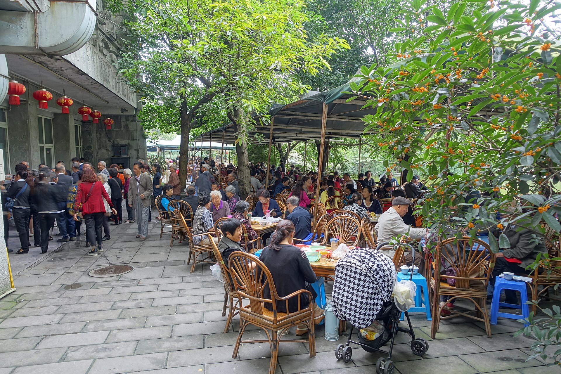 A traditional Chinese teahouse interior with wooden tables and tea drinkers