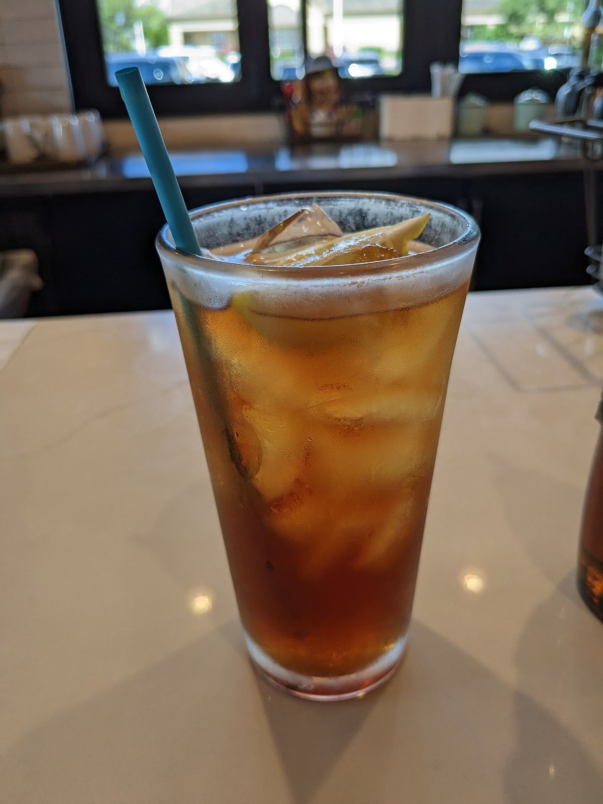 A glass of iced tea with lemon