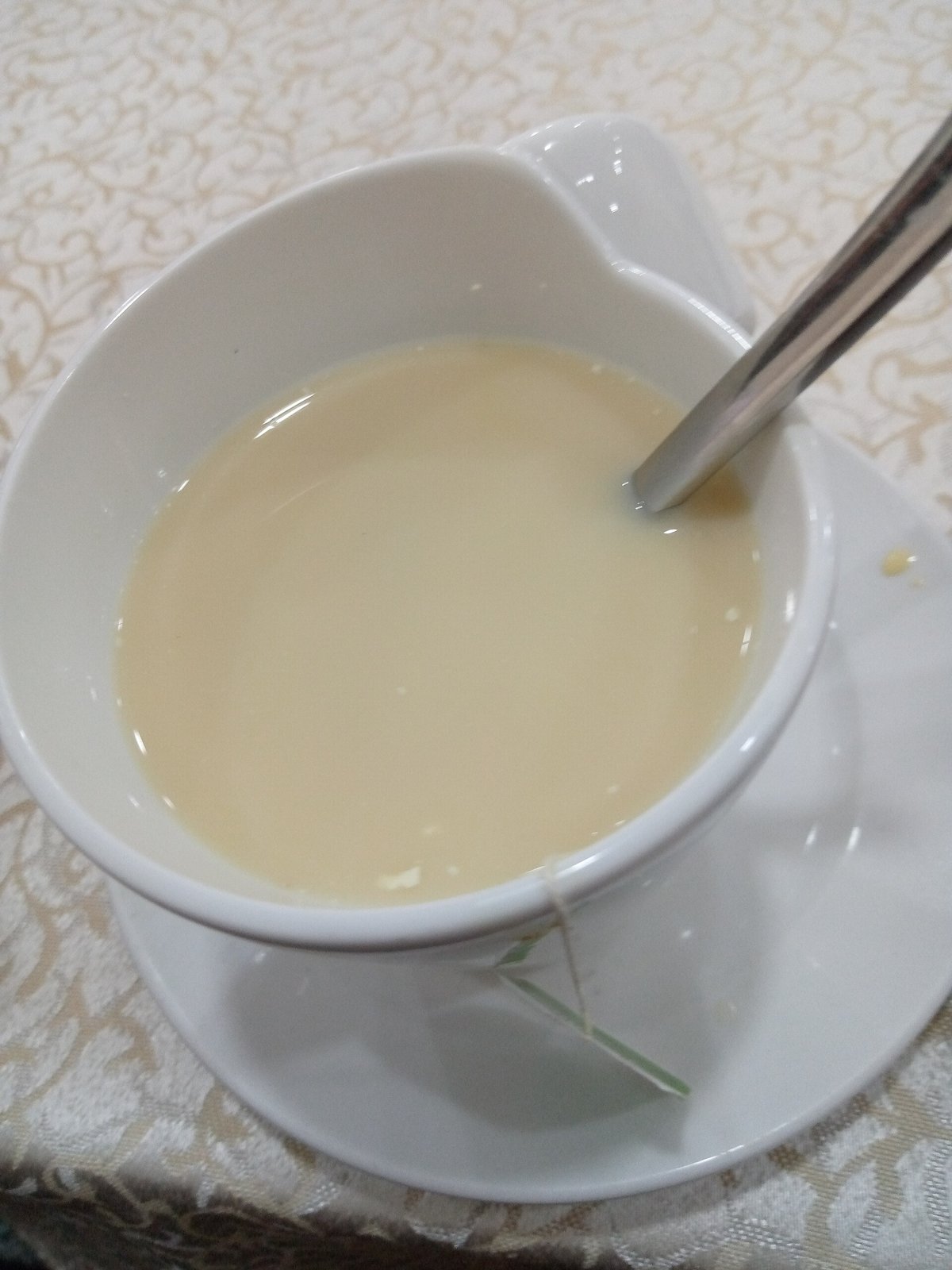 A glass cup of brewed green tea