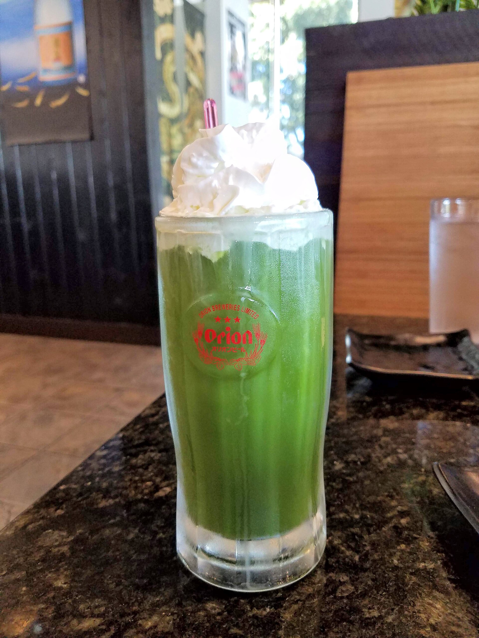 Bright green matcha powder being whisked in a tea bowl
