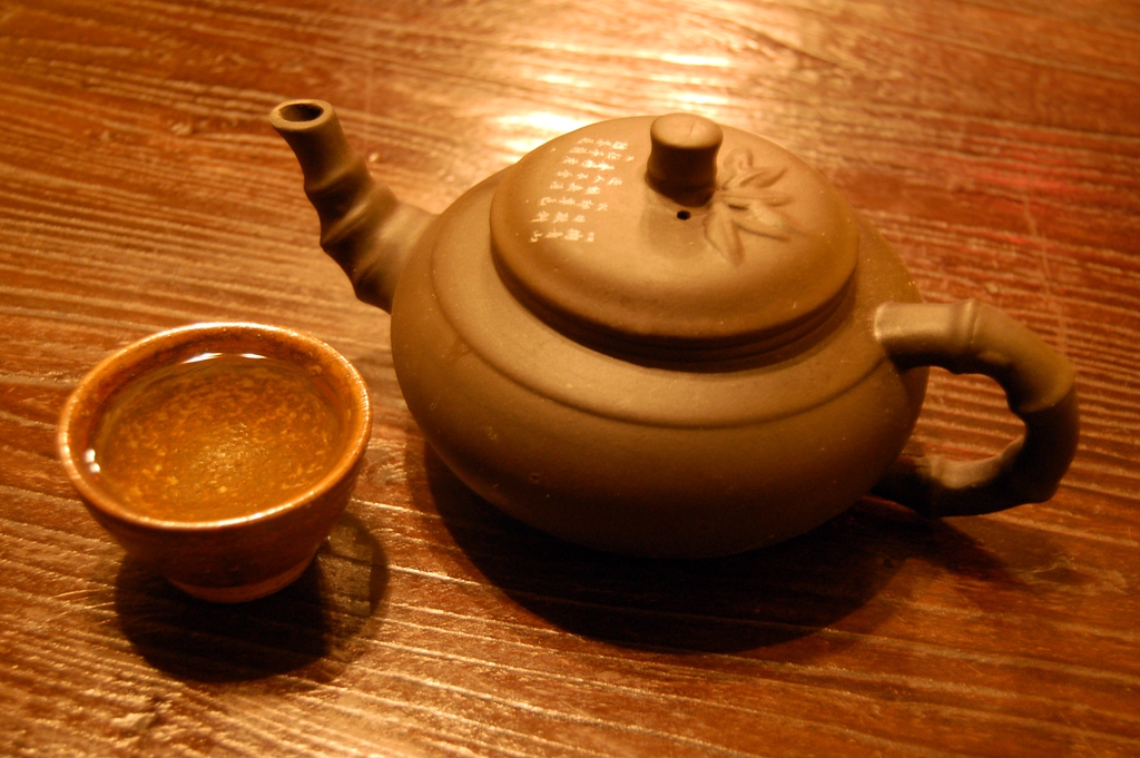 Cups of tea in different colors from pale green to deep amber