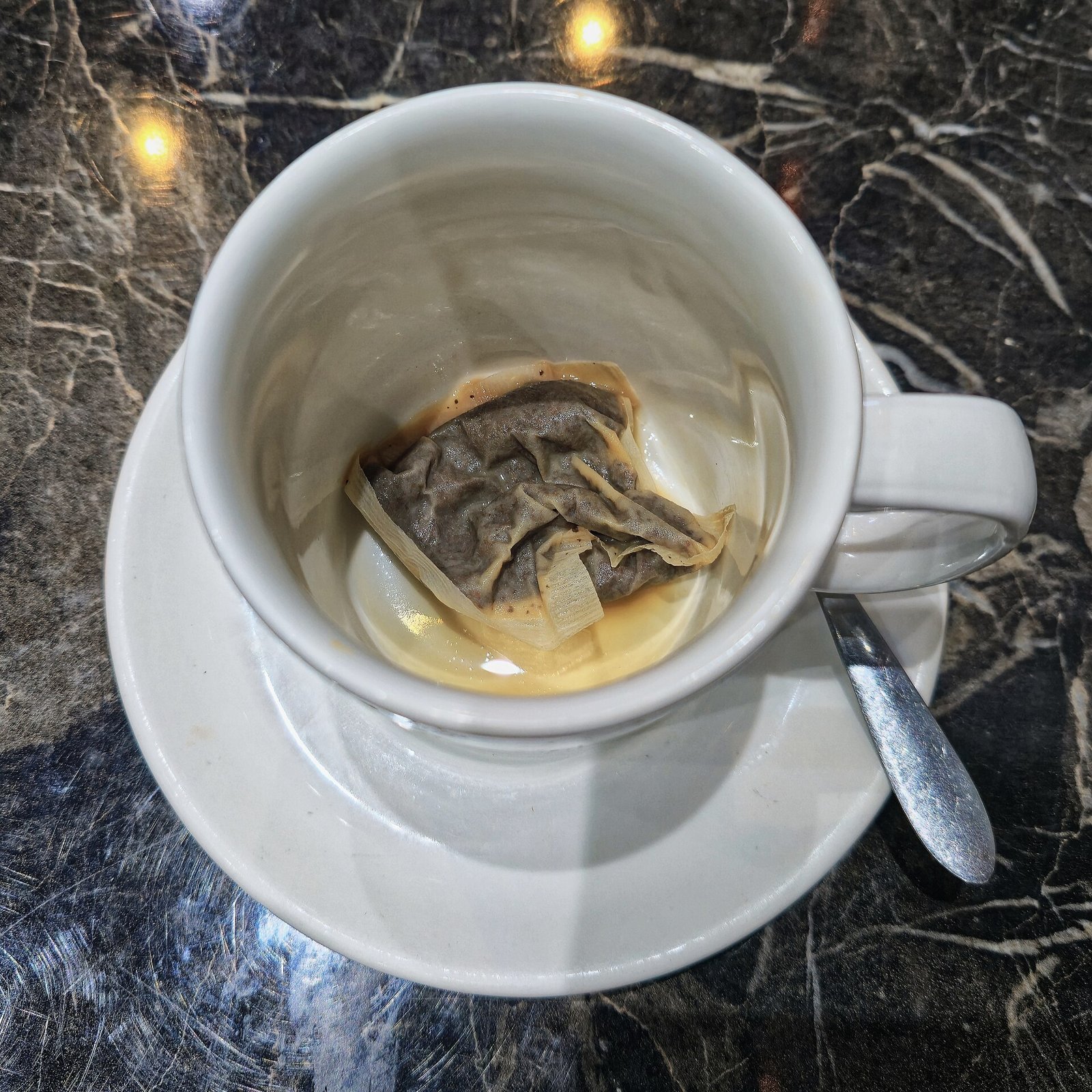 An empty ceramic mug with light tea staining inside